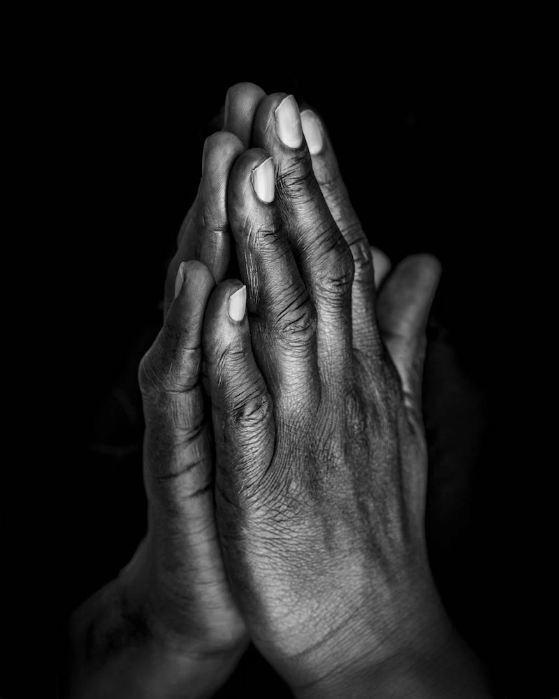 Black hands in prayer