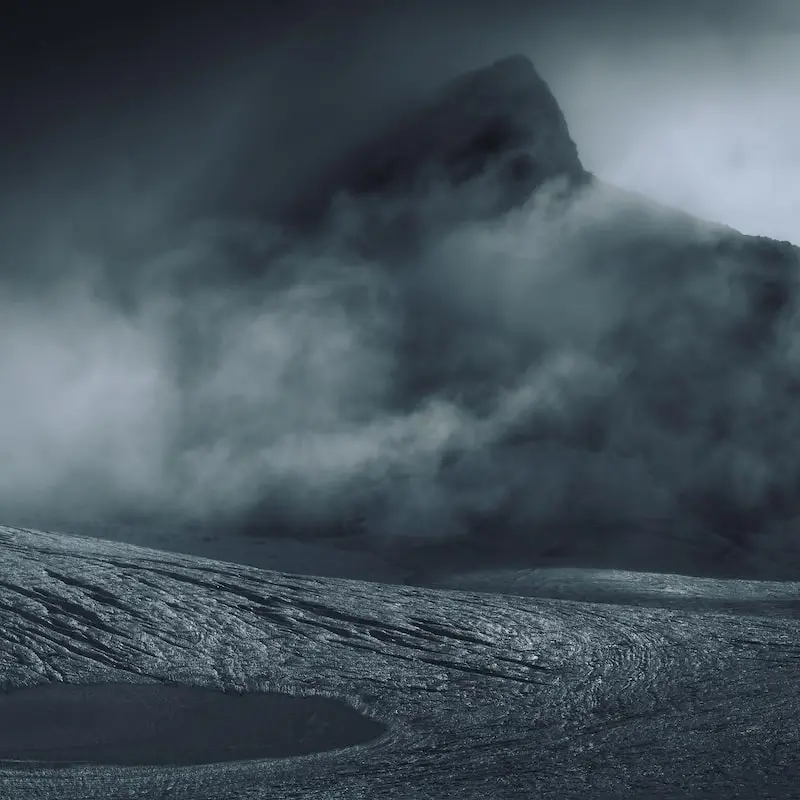 Photography of a foggy landscape with a mountain in the background