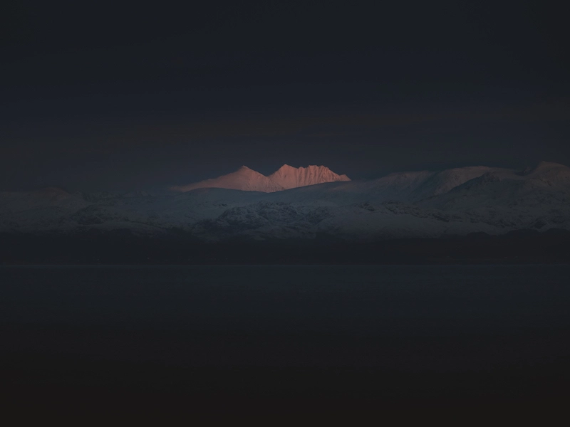 Photography of a mountain enlightened by the sun